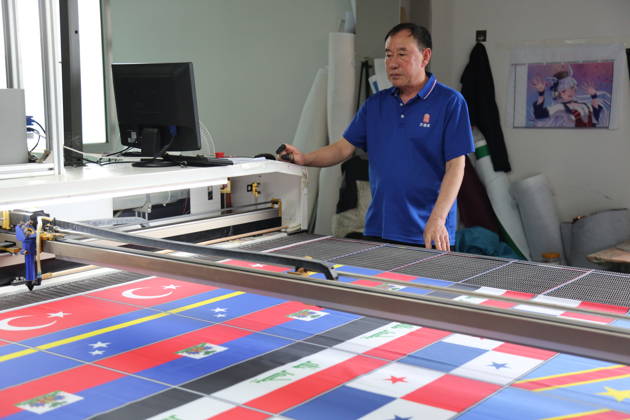 QINGDAO, CHINA - MAY 28: Workers are busy in front of an assembly line of flags for the FIFA World Cup at Qingdao Wonderful Flag Industry Co on May 28, 2026 in Qingdao, Shandong Province of China. As the 2026 FIFA World Cup is around the corner, production lines at a flag manufacturer in Qingdao, Shandong province, are running at full speed to produce various types of flags, many of which will soon appear in stadiums across North America.  Copyright: xVCGx 111644648664