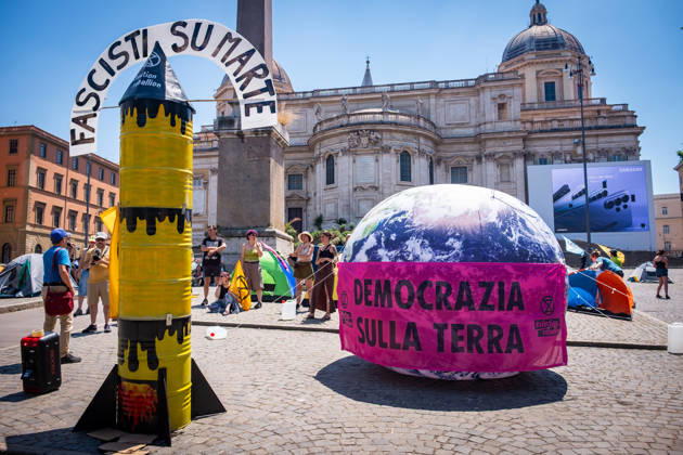 May 30, 2026, Rome, Rm, Italy: Extinction Rebellion activists are launching a 24-hour rally in Piazza dell Esquilino, just days before the 80th anniversary of the Italian Republic on June 2nd. They say: there is nothing to celebrate as long as rights, justice, and dignity continue to be denied. Oil extraction is imposed through violence and war to produce ever more energy, further increasing inequality. Activists assembled a rocket made of oil drums. It reads: Fascists on Mars. Democracy on earth reads the banner. Rome Italy  - ZUMAg256 20260530_znp_g256_002 Copyright: xMarcoxDixGianvitox