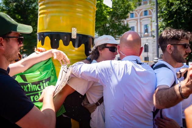 May 30, 2026, Rome, Rm, Italy: Extinction Rebellion activists are launching a 24-hour rally in Piazza dell Esquilino, just days before the 80th anniversary of the Italian Republic on June 2nd. They say: there is nothing to celebrate as long as rights, justice, and dignity continue to be denied. Oil extraction is imposed through violence and war to produce ever more energy, further increasing inequality. Plainclothes police remove drawings of Donald Trump and Giorgia Meloni pinned to a rocket made of oil drums. Rome Italy - ZUMAg256 20260530_znp_g256_012 Copyright: xMarcoxDixGianvitox