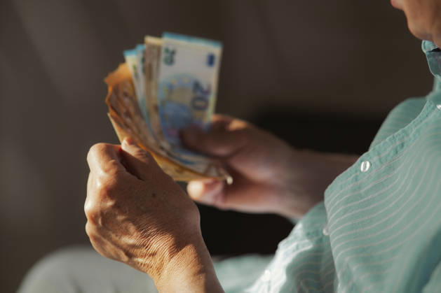 Hands holding euro banknotes indoors for saving and investment model released, Symbolfoto, AZF01272