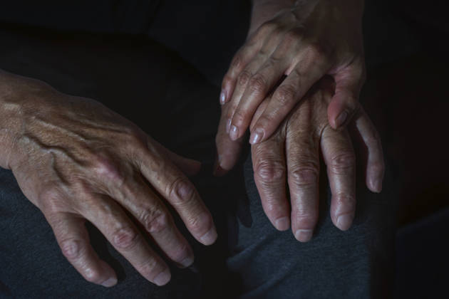 Doctor holding hand offering comfort and healthcare support indoors model released, Symbolfoto, AZF01284