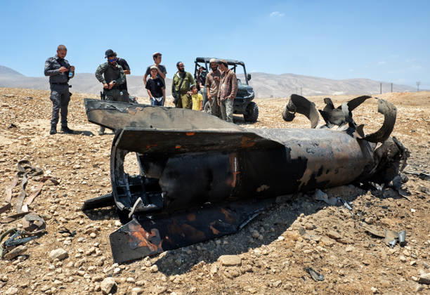Israeli military personnel and Jewish settlers look at the remains of an Iranian ballistic that was removed from the desert landscape in the area near Jericho, in the West Bank on Monday, June 8, 2026 after it was intercepted by Israel and fell to the desert. Iran fired barrages of missiles and Israel carried out military strikes on both Beirut and Iran. Both Iran and Israel have signaled they would wind down the military escalation that shattered the two month ceasefire.  ISR20260608008 JimxHollander