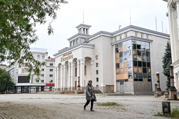 RECORD DATE NOT STATED A woman walks past the damaged Ukraina cinema in the red zone of the frontline city of Kherson, the area considered the most dangerous due to constant Russian attacks, Kherson, Ukraine, on June 3, 2026. The Russian army attacks the city daily with FPV drones and other unmanned aerial vehicles, deliberately terrorizing civilians. Russian forces conduct hunts for local residents, tracking them with FPV drones and dropping explosives. Police officers, medics, public transport, and urban infrastructure are also targeted. Based on the intensity of attacks, Kherson is informally divided into yellow and red zones, with the red zone subjected to continuous shelling and drone strikes. Anti-drone netting has been installed above roads to he Copyright: xDmytroxSmolienkox