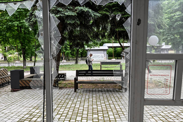 RECORD DATE NOT STATED Lone pedestrians are seen through a shattered storefront window in the red zone of the frontline city of Kherson, the area considered the most dangerous due to constant Russian attacks, Kherson, Ukraine, on June 3, 2026. The Russian army attacks the city daily with FPV drones and other unmanned aerial vehicles, deliberately terrorizing civilians. Russian forces conduct hunts for local residents, tracking them with FPV drones and dropping explosives. Police officers, medics, public transport, and urban infrastructure are also targeted. Based on the intensity of attacks, Kherson is informally divided into yellow and red zones, with the red zone subjected to continuous shelling and drone strikes. Anti-drone netting has been installed Copyright: xDmytroxSmolienkox