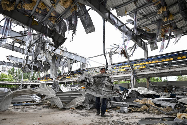 RECORD DATE NOT STATED A worker carries a sheet of corrugated metal while clearing debris at the site of the Favoryt Arena ice sports palace, destroyed in Russian guided aerial bomb (KAB) strikes, in the frontline city of Kherson, Ukraine, on June 3, 2026. The Russian army attacks the city daily with FPV drones and other unmanned aerial vehicles, deliberately terrorizing civilians. Russian forces conduct hunts for local residents, tracking them with FPV drones and dropping explosives. Police officers, medics, public transport, and urban infrastructure are also targeted (Photo by Dmytro Smolienko Ukrinform) Life under shelling in frontline Kherson Copyright: xDmytroxSmolienkox