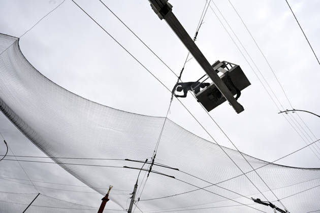 RECORD DATE NOT STATED A municipal worker installs anti-drone netting to protect against Russian FPV drones in the yellow zone of the frontline city of Kherson, Ukraine, on June 3, 2026. The Russian army attacks the city daily with FPV drones and other unmanned aerial vehicles, deliberately terrorizing civilians. Russian forces conduct hunts for local residents, tracking them with FPV drones and dropping explosives. Police officers, medics, public transport, and urban infrastructure are also targeted. Based on the intensity of attacks, Kherson is informally divided into yellow and red zones, with the red zone being the most dangerous due to constant shelling and drone strikes (Photo by Dmytro Smolienko Ukrinform) Life under shelling in frontline Kherson Copyright: xDmytroxSmolienkox