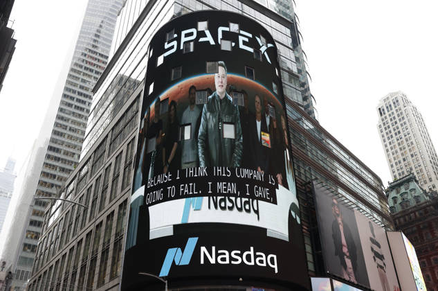 Spectators watch the screens in Times Square showing visuals of Elon Musk and SpaceX branding at the Nasdaq MarketSite Exchange in Times Square on Friday, June 12, 2026 in New York City. Elon Musk celebrated the Nasdaq opening bell Friday as SpaceX prepared to start trading publicly and possibly cementing his status as a trillionaire.  NYP20260612211 JOHNxANGELILLO