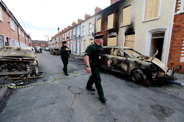 Aftermath of the race riots in Belfast BELFAST, NORTHERN IRELAND - JUNE 12: Police walk between the burned cars on the street as a clean-up operation is under way after a race riots erupted in Belfast, Northern Ireland, on June 12, 2026. Twelve police officers were injured and 27 people made homeless during two nights of unrest. Conor McCaughley Anadolu Belfast Northern Ireland. Editorial use only. Please get in touch for any other usage.  Copyright: x2026xAnadoluxConorxMcCaughleyx