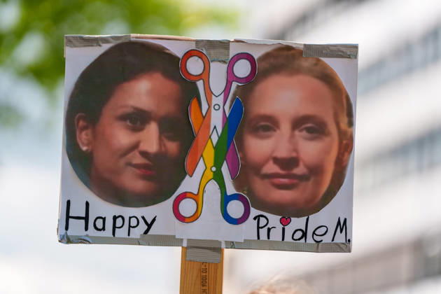 News Bilder des Tages Pride March and Demonstration During CSD in Kassel Germany - Kassel, 13.06.2026 A participant carries a protest sign featuring two portraits that appear to depict German politician Alice Weidel at the Christopher Street Day (CSD) march. The sign includes a rainbow-colored pair of scissors and the words Happy Pride?. The message appears to be a satirical reference to LGBTQ+ rights and contemporary political debates in Germany. Hesse