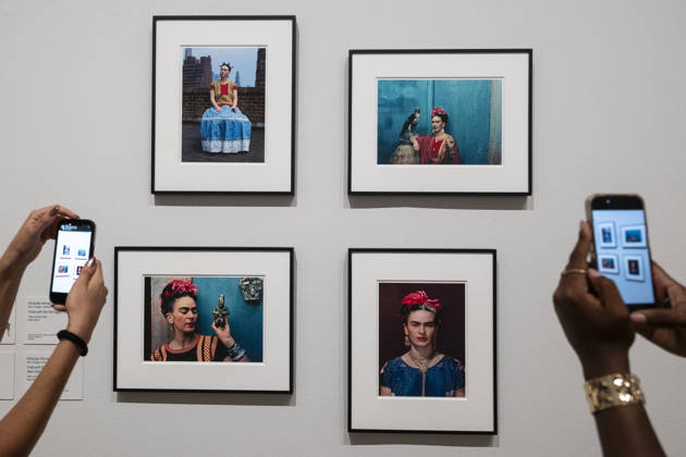 June 22, 2026, London, London, UK: LONDON, UK. Staff with portraits by Nickolas Muray, 1939 1946, at a preview of Frida: The Making of an Icon, a new exhibition at Tate Modern tracing Mexican painterÃ¢â‚¬â ¢s KahloÃ¢â‚¬â ¢s transformation from relatively unknown painter to global cultural phenomenon. Over 30 original works by Frida Kahlo alongside other works are on show runs 25 June 2026 to 3 January 2027. London UK  - ZUMAl94_ 20260622_zaf_l94_044 Copyright: xStephenxChungx
