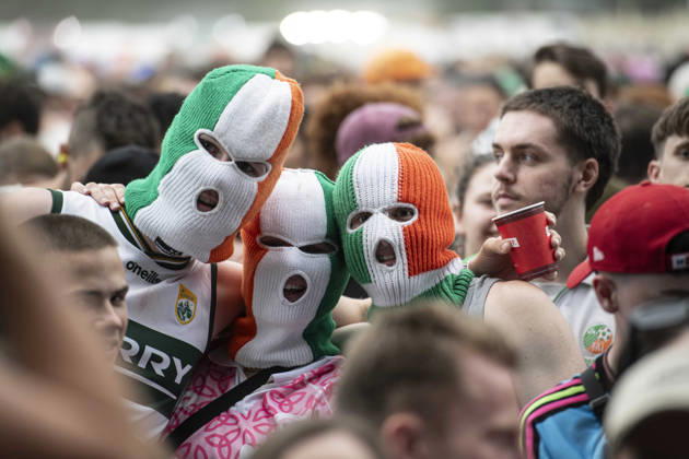 Kneecap performing live at Crystal Palace Park, London 27 June 2026 Kneecap performing live at Crystal Palace Park, London 27 June 2026 Fans in the crowd Kneecap are an Irish hip-hop trio. They rap in a mixture of English and Irish. Their first single C.E.A.R.T.A. (cearta is Irish for rights ) was released in ˜17, followed by their mixtape, 3CAG, in ˜18. Their first studio album, Fine Art, was released in ˜24 Their second studio album, Fenian, was released in ˜26. The group has been at the centre of public debates about free speech and the expression of political opinions within Ireland and the UK. Their themes focus on working class, youth culture, Irish republicanism and Irish language rights. In concert, they have made stateme Copyright: xDafyddxOwenx xDafyddxOwenx-xB5377x xAvalonx 1112995169
