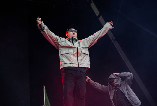 Kneecap performing live at Crystal Palace Park, London 27 June 2026 Kneecap performing live at Crystal Palace Park, London 27 June 2026 Mo Chara (Liam Og O hAnnaidh) - rapper, vocals Kneecap are an Irish hip-hop trio. They rap in a mixture of English and Irish. Their first single C.E.A.R.T.A. (cearta is Irish for rights ) was released in ˜17, followed by their mixtape, 3CAG, in ˜18. Their first studio album, Fine Art, was released in ˜24 Their second studio album, Fenian, was released in ˜26. The group has been at the centre of public debates about free speech and the expression of political opinions within Ireland and the UK. Their themes focus on working class, youth culture, Irish republicanism and Irish language rights. In Copyright: xDafyddxOwenx xDafyddxOwenx-xB5377x xAvalonx 1112995508