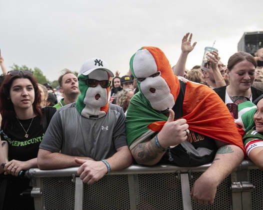 Kneecap performing live at Crystal Palace Park, London 27 June 2026 Kneecap performing live at Crystal Palace Park, London 27 June 2026 Fans in the crowd Kneecap are an Irish hip-hop trio. They rap in a mixture of English and Irish. Their first single C.E.A.R.T.A. (cearta is Irish for rights ) was released in ˜17, followed by their mixtape, 3CAG, in ˜18. Their first studio album, Fine Art, was released in ˜24 Their second studio album, Fenian, was released in ˜26. The group has been at the centre of public debates about free speech and the expression of political opinions within Ireland and the UK. Their themes focus on working class, youth culture, Irish republicanism and Irish language rights. In concert, they have made stateme Copyright: xDafyddxOwenx xDafyddxOwenx-xB5377x xAvalonx 1112996542