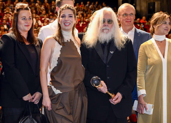 The 60th Karlovy Vary International Film Festival continued on its second day, in Karlovy Vary, Czech Republic, on July 5, 2026. Cameraman Robert Richardson (holding the trophy) accepted the Crystal Globe for Outstanding Artistic Contribution to World Cinema and introduced the documentary film Robert Richardson: The White Devil by director and cameraman Jana Hojdova (to his right). (CTKxPhoto KaterinaxSulova) CTKPhotoP2026070503720  CTKPhotoP2026070503720