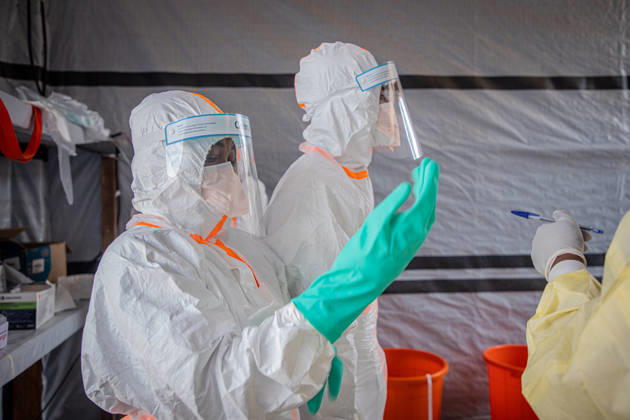 (260706) -- BUNIA, July 6, 2026 -- Medical workers put on protective suits at an Ebola treatment center in Bunia, the capital of Ituri Province in the Democratic Republic of the Congo, July 6, 2026. The death toll from the latest Ebola outbreak in the Democratic Republic of the Congo has surpassed 500, according to a report released Sunday by the country s health authorities. DR CONGO-BUNIA-EBOLA OUTBREAK-DEATH XinxHuashefa 