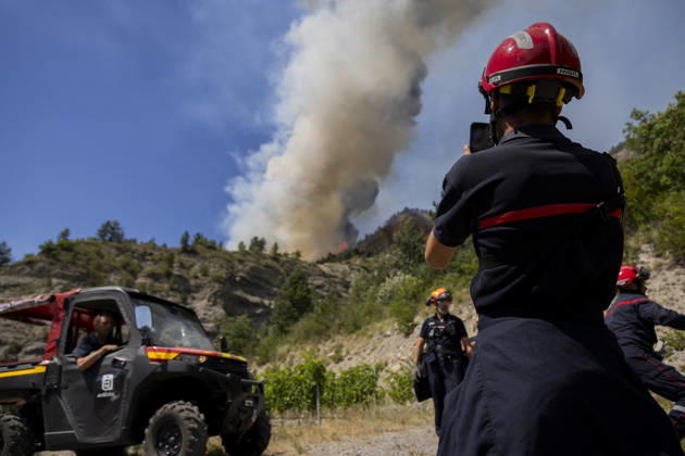 Wildfire Threatens Village Of Aurel - France A huge plume of smoke rises from the wildfire just above a team of firefighters monitoring its progress. A wildfire is currently burning in the Drome region, where it is dangerously approaching the village of Aurel. France, Drome, Aurel, July 8, 2026. Photo by Thibaut Durand ABACAPRESS.COM Aurel Auvergne-Rhone-Alpes France  Copyright: xDurandxThibaut ABACAx
