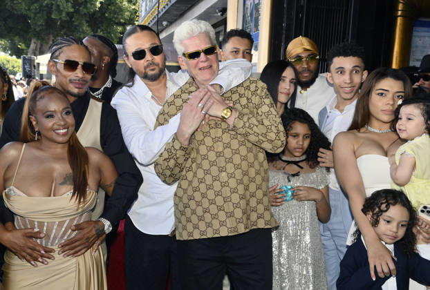 Bizzy Bone of the Hip-Hop group Bone Thugs-N-Harmony hugs his father Robert Cass Floyd during a ceremony honoring them with the 2,851st star on the Hollywood Walk of Fame in Los Angeles on Wednesday, July 8, 2026. At left is Layzie Bone and his wife Felecia Lindsey-Howse.  LAP2026070819 JIMxRUYMEN