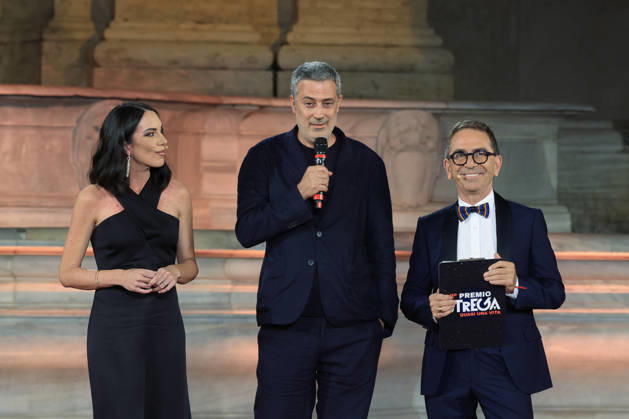 July 8, 2026, Rome, Rome, Italy: Hosts Gloria Campaner, left, and Pino Strabioli, right, with last year s winner Andrea Bajani, during the final evening of the eightieth edition of the Strega Prize literary competition in Piazza del Campidoglio, Rome, July 8, 2026. Rome Italy - ZUMAa289 20260708_zia_a289_254 Copyright: xRiccardoxDexLucax xAgfx