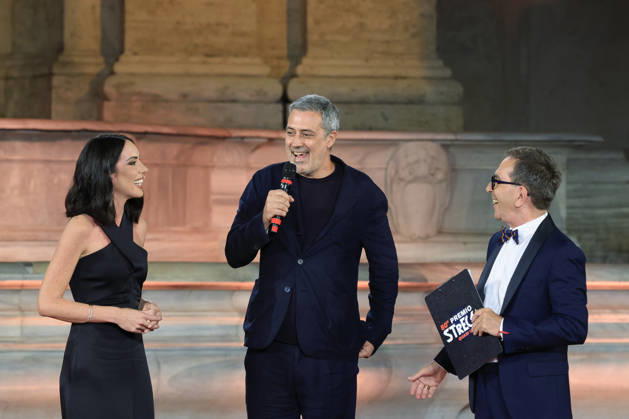 July 8, 2026, Rome, Rome, Italy: Hosts Gloria Campaner, left, and Pino Strabioli, right, with last year s winner Andrea Bajani, during the final evening of the eightieth edition of the Strega Prize literary competition in Piazza del Campidoglio, Rome, July 8, 2026. Rome Italy - ZUMAa289 20260708_zia_a289_255 Copyright: xRiccardoxDexLucax xAgfx