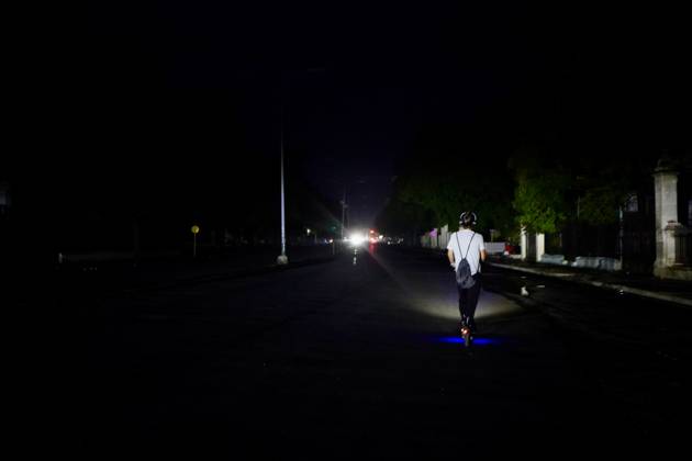 (260711) -- HAVANA, July 11, 2026 -- A man rides an electric scooter on a street during a blackout in Havana, Cuba, July 10, 2026. Cuba was hit by another nationwide blackout on Friday, as the country s power system completely collapsed at 4:30 p.m. local time, according to the National Electric Union. ) CUBA-HAVANA-NATIONAL BLACKOUT-STREET VIEWS JiangxBiao 