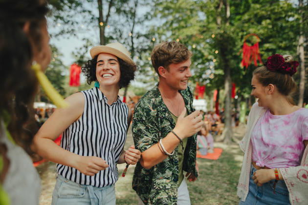 Group of young friends at summer festival. Group of cheerful young friends at summer festival, looking at camera. model released