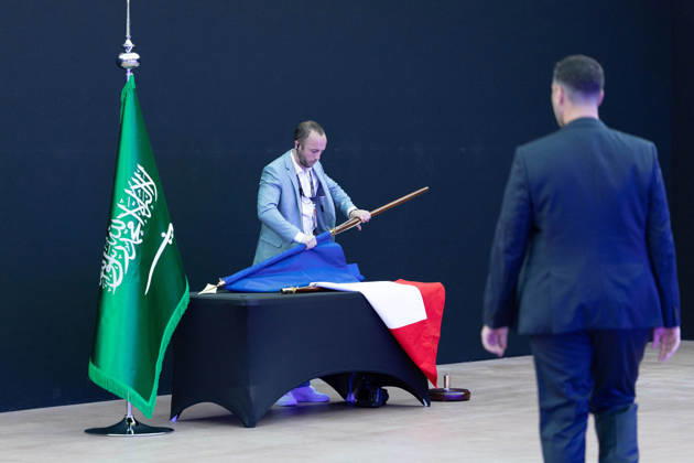 Emmanuel Macron And Mohammed Bin Salman Attend Esports World Cup Closing Ceremony - Paris A man put away a French flag next to a Saudi Arabia flag after the signing of an accord of cooperation about sports ahead of the closing ceremony of the Esports World Cup at the Grand Palais in Paris, France, 23 August 2026. Photo by Raphael Lafargue ABACAPRESS.COM Paris Ile-de-France France  Copyright: xLafarguexRaphael ABACAx