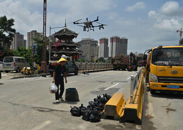(260825) -- CHONGZUO, Aug. 25, 2026 -- A rescuer operates a drone to transport supplies in Ningming Couty, Chongzuo City, south China s Guangxi Zhuang Autonomous Region, Aug. 25, 2026. Continuous heavy rainfalls caused by Typhoon Narra, the 19th typhoon of the year, have swept many areas in Ningming. Local authorities have fully engaged in rescue and relief efforts. As of 12:00 p.m. (Beijing Time) on Tuesday, 22,008 stranded civilians had been transferred. ) CHINA-GUANGXI-NINGMING-TYPHOON-STRANDED RESIDENTS-TRANSFER (CN) ZhouxHua