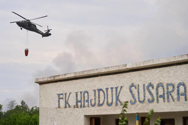 August 25, 2026, Susara, Vojvodina, Serbia: 2026825, Susara, Serbia - Two Sikorsky UH-60 Black Hawk helicopters are deployed to the village of Susara to help battle the severe wildfires devastating the Deliblato Sands (Deliblatska Pescara) Special Nature Reserve, refilling their buckets from a large portable water tank placed on a local football pitch. Susara Serbia  - ZUMAd223 20260825_zip_d223_003 Copyright: xMarkoxDimicx