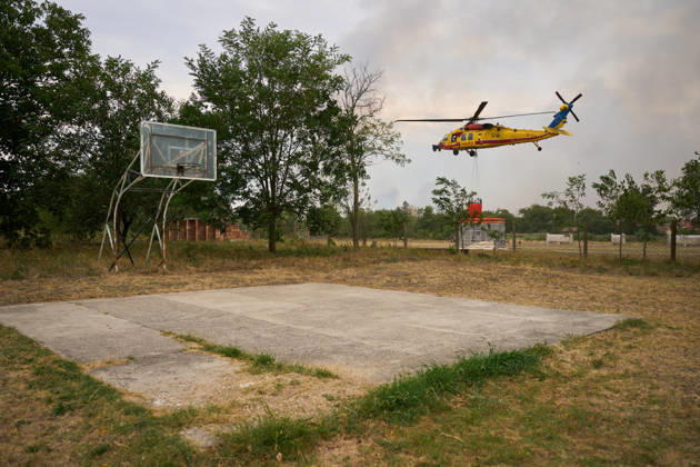 August 25, 2026, Susara, Vojvodina, Serbia: 2026825, Susara, Serbia - Two Sikorsky UH-60 Black Hawk helicopters are deployed to the village of Susara to help battle the severe wildfires devastating the Deliblato Sands (Deliblatska Pescara) Special Nature Reserve, refilling their buckets from a large portable water tank placed on a local football pitch. Susara Serbia - ZUMAd223 20260825_zip_d223_008 Copyright: xMarkoxDimicx