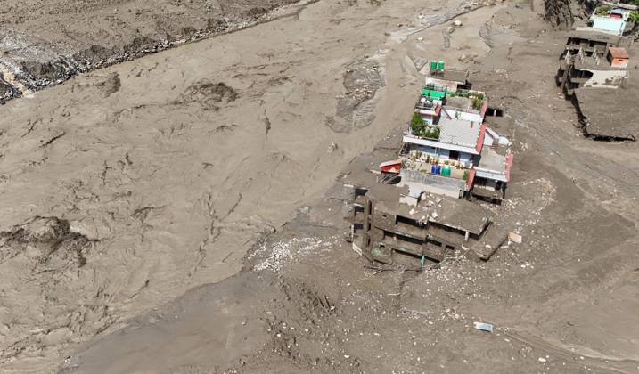 August 26, 2026, Nuwakot, Nepal: An aerial view shows buildings and infrastructure damaged along the swollen Trishuli River following a massive flash flood triggered by an avalanche of ice and rock in the upper Lhende River on the Tibetan side, in Nuwakot district, Nepal, on Wednesday, August 26, 2026. The sudden flood swept through communities along the Bhote Koshi and Trishuli river systems, destroying homes, roads and bridges and leaving widespread devastation downstream. Nuwakot Nepal  - ZUMAg200 20260826_zap_g200_013 Copyright: xSkandaxGautamx