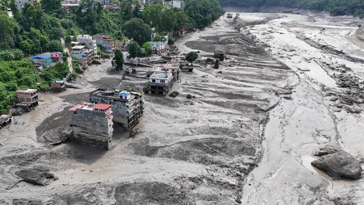 August 26, 2026, Nuwakot, Nepal: An aerial view shows buildings and infrastructure damaged along the swollen Trishuli River following a massive flash flood triggered by an avalanche of ice and rock in the upper Lhende River on the Tibetan side, in Nuwakot district, Nepal, on Wednesday, August 26, 2026. The sudden flood swept through communities along the Bhote Koshi and Trishuli river systems, destroying homes, roads and bridges and leaving widespread devastation downstream. Nuwakot Nepal  - ZUMAg200 20260826_zap_g200_018 Copyright: xSkandaxGautamx