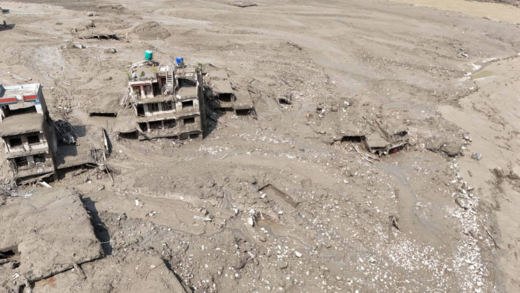 August 26, 2026, Nuwakot, Nepal: An aerial view shows buildings and infrastructure damaged along the swollen Trishuli River following a massive flash flood triggered by an avalanche of ice and rock in the upper Lhende River on the Tibetan side, in Nuwakot district, Nepal, on Wednesday, August 26, 2026. The sudden flood swept through communities along the Bhote Koshi and Trishuli river systems, destroying homes, roads and bridges and leaving widespread devastation downstream. Nuwakot Nepal - ZUMAg200 20260826_zap_g200_021 Copyright: xSkandaxGautamx