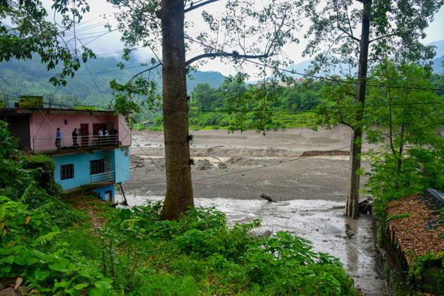 August 26, 2026, Kathmandu, Bagmati, Nepal: NUWAKOT, NEPAL - AUGUST 26: An aftermath view of flash floods and mudslides along the Trishuli River in Nuwakot, Nepal, on August 26, 2026. A catastrophic flash flood swept through Nepalâ€⠢s northern border region after an ice-and-rock avalanche, reportedly triggered by an earthquake, caused a sudden surge in the Lhende River on the Nepal-China border and sent massive volumes of water, mud and debris downstream into the Bhote Koshi and Trishuli river systems. The disaster devastated settlements in Rasuwa and Nuwakot districts, sweeping away homes, roads, bridges, vehicles and other infrastructure and severely damaging hydropower and power facilities. In Nuwakot, riverside settlements includin - ZUMAs330 20260826_zsp_s330_067 Copyright: xSafalxPrakashxShresthax