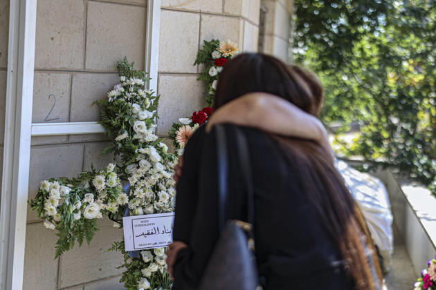 Palestinians Mourn Artist Sliman Mansour A Mourner stands beside a floral tribute during the funeral of renowned Palestinian artist Sliman Mansour in Birzeit, north of Ramallah, in the occupied West Bank, on August 26, 2026. Mansour, one of the most prominent figures in contemporary Palestinian visual art, died on August 24 at the age of 79 and was known for works depicting Palestinian landscapes, heritage and life under Israeli occupation, including his 1973 painting Camel of Hardships. Ramallah West Bank Palestinian Territories Copyright: xMohammadxNazzalx