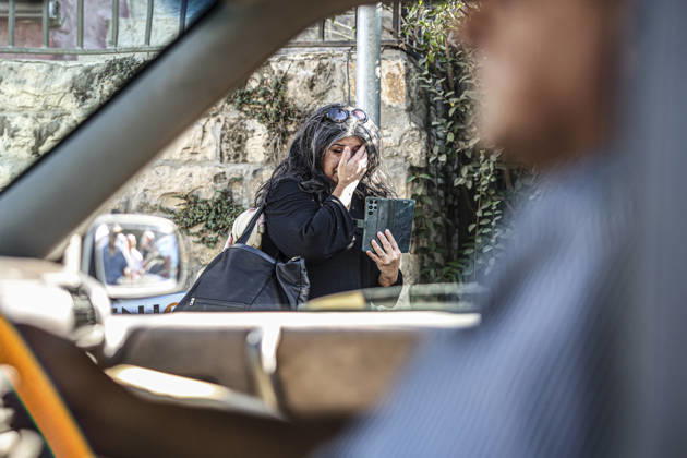 Palestinians Mourn Artist Sliman Mansour A woman wipes tears while standing beside a vehicle during the funeral of renowned Palestinian artist Sliman Mansour in Birzeit, north of Ramallah, in the occupied West Bank, on August 26, 2026. Mansour, one of the most prominent figures in contemporary Palestinian visual art, died on August 24 at the age of 79 and was known for works depicting Palestinian landscapes, heritage and life under Israeli occupation, including his 1973 painting Camel of Hardships. Ramallah West Bank Palestinian Territories Copyright: xMohammadxNazzalx