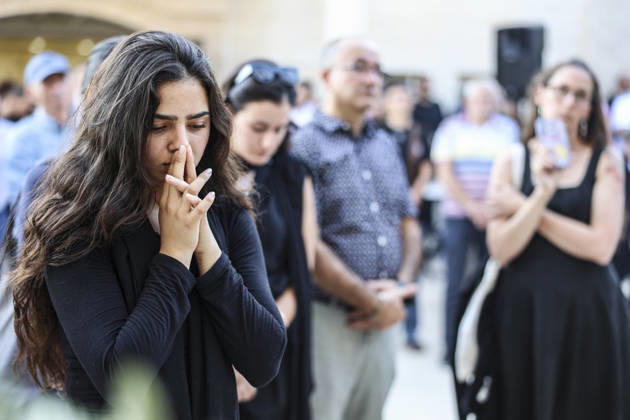 Palestinians Mourn Artist Sliman Mansour A young woman clasps her hands during the funeral service for renowned Palestinian artist Sliman Mansour in Birzeit, north of Ramallah, in the occupied West Bank, on August 26, 2026. Mansour, one of the most prominent figures in contemporary Palestinian visual art, died on August 24 at the age of 79 and was known for works depicting Palestinian landscapes, heritage and life under Israeli occupation, including his 1973 painting Camel of Hardships. Ramallah West Bank Palestinian Territories Copyright: xMohammadxNazzalx