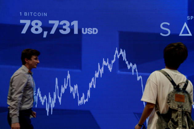 Bitcoin Asia Hong Kong 2026 People walking pass a digital display board showing the price of Bitcoin at Bitcoin Asia 2026 on August 27, 2026 in Hong Kong. (Photo by Vernon Yuen Nexpher Images) HONG KONG