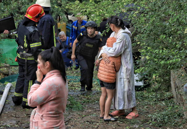 A woman hugs a boy during a response effort to a Russian attack in the Prymorskyi district of Odesa, Ukraine, August 27, 2026. On the night and morning of August 27, the Russian Federation attacked Odesa. The Russian army massively attacked Odesa with missiles and drones. The Russian strikes damaged infrastructure, an academic institution, and a multi-storey building. (Photo by Nina Liashonok Ukrinform) Odesa hit by overnight and daytime Russian strikes  Copyright: xNinaxLiashonokx