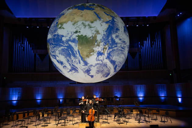 Luke Jerram s Earth Installation GAIA Suspended over Royal Festival Hall Stage at Royal Festival Hall, London, UK - Thursday 27 August 2026 A General view of GAIA by Luke Jerram with members of the BBC Concert Orchestra at Royal Festival Hall, London, England, UK on Thursday 27 August, 2026. The Installation runs from Friday 28th August - 30th August 2026 and Orchestral performances from the BBC Concert Orchestra will take place on Friday 28th and Saturday 29th August 2026., Credit:Justin Ng Avalon UK, England, London, Royal Festival Hall Copyright: xJustinxNgx xAvalonx 1128810189