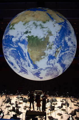 Luke Jerram s Earth Installation GAIA Suspended over Royal Festival Hall Stage at Royal Festival Hall, London, UK - Thursday 27 August 2026 A General view of GAIA by Luke Jerram with members of the BBC Concert Orchestra at Royal Festival Hall, London, England, UK on Thursday 27 August, 2026. The Installation runs from Friday 28th August - 30th August 2026 and Orchestral performances from the BBC Concert Orchestra will take place on Friday 28th and Saturday 29th August 2026., Credit:Justin Ng Avalon UK, England, London, Royal Festival Hall Copyright: xJustinxNgx xAvalonx 1128810190