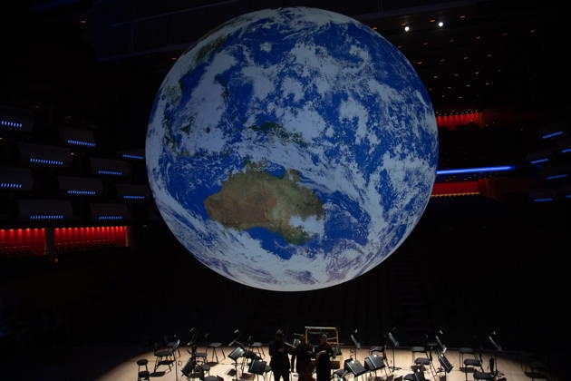 Luke Jerram s Earth Installation GAIA Suspended over Royal Festival Hall Stage at Royal Festival Hall, London, UK - Thursday 27 August 2026 A General view of GAIA by Luke Jerram with members of the BBC Concert Orchestra at Royal Festival Hall, London, England, UK on Thursday 27 August, 2026. The Installation runs from Friday 28th August - 30th August 2026 and Orchestral performances from the BBC Concert Orchestra will take place on Friday 28th and Saturday 29th August 2026., Credit:Justin Ng Avalon UK, England, London, Royal Festival Hall Copyright: xJustinxNgx xAvalonx 1128810194