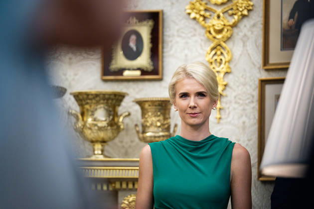 Natalie Harp, executive assistant to President Donald Trump, listens as President Donald Trump, not pictured, signs an executive order to rename Lake Ontario as Lake America, amid a recent trade war with Canada, in the Oval Office of the White House in Washington, DC on Thursday, August 27, 2026.  WASP20260827105 AlxDrago