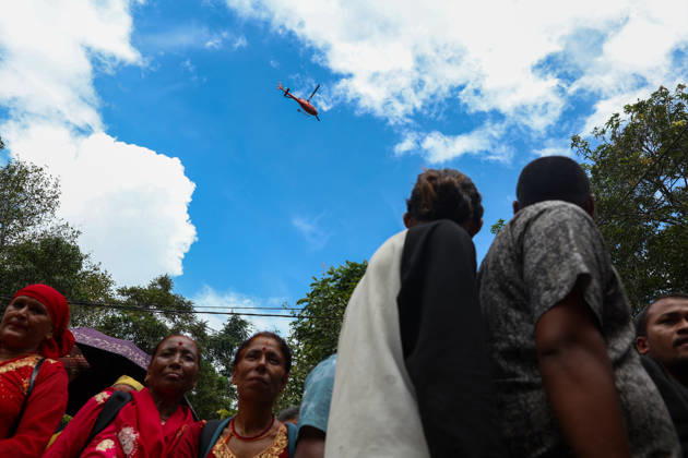 Nepal-China flash flood death toll rises to at least 469, hundreds remain missing NUWAKOT, NEPAL - AUGUST 28: A rescue helicopter flies over as people wait for updates on their missing relatives, as search and rescue operations continue, following landslide and flash floods in areas near Nepal-China border, in Bidur, Nuwakot, Nepal, on August 28, 2026. Death toll from the disaster has so far risen to at least 469, with hundreds of people missing, including foreign nationals from 32 countries such as China, Malaysia, South Korea, Australia, the United Kingdom, India and the United States. Daniel Ceng Anadolu Nuwakot Nepal. Editorial use only. Please get in touch for any other usage. Copyright: x2026xAnadoluxDanielxCengx