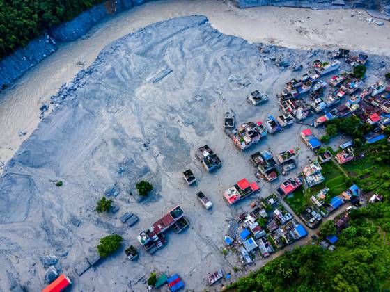 August 28, 2026, Nuwakot, Bagmati, Nepal: NUWAKOT, NEPAL †AUGUST 28, 2026: An aerial view shows the aftermath of severe flooding along the Bhotekoshi River in Nuwakot, Nepal. The flooding affected low-lying areas and settlements near the riverbanks, causing widespread damage to homes, roads, bridges, a hydropower station and other infrastructure. Several people remain missing as authorities continue to assess the extent of the disaster. Rescue teams and security personnel are conducting search and rescue operations in the affected areas. Nuwakot Nepal - ZUMAq101 20260828_zna_q101_128 Copyright: xAmbirxTolangx