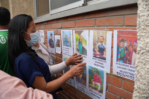 Families Seek Missing Relatives After Devastating Mudslide - Nepal Relatives examine photographs of individuals reported missing following devastating flash floods in Nepal, displayed outside Tribhuvan University Teaching Hospital in Kathmandu, Nepal on August 28, 2026. Photo by Sunil Pradhan ABACAPRESS.COM Kathmandu Bagmati Nepal  Copyright: xSuniixPradhan ABACAx