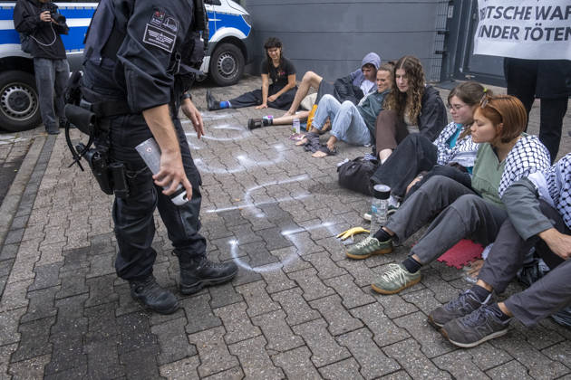 Protest against Rheinmetall in Germany BONN, GERMANY - AUGUST 28: Activists block the entrance to a Rheinmetall facility during a protest against the German arms manufacturer in Bonn, Germany, on August 28, 2026. Demonstrators staged the blockade as part of a nationwide mobilization protesting Rheinmetall’s involvement in the defense industry and its supply of military equipment amid the war in Gaza. Several participants glued themselves to the ground, prompting police to deploy a technical unit during a six-hour operation that ended with the arrest and detention of all blockade participants. Mouafak Mahmalji Anadolu Bonn Germany. Editorial use only. Please get in touch for any other usage.  Copyright: x2026xAnadoluxMouafakxMahmaljix