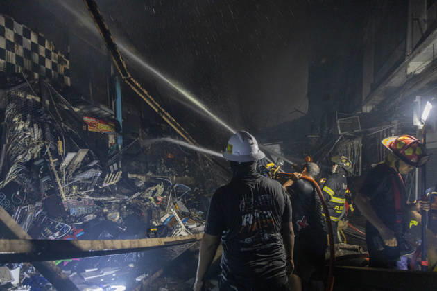 Bangkok Fire Engulfs Klongthom Centre Firefighters stand amid charred debris and damaged shop structures as extinguishing operations continue at Klongthom Centre on Worachak Road in Pom Prap Sattru Phai, Bangkok, Thailand, on August 28, 2026. The fire was reported at 8:42 p.m. at Klongthom Centre on Worachak Road, where flames spread from a ground-floor shop across the ground floor and mezzanine beneath the parking area; parts of the structure subsided, several emergency personnel were injured, and firefighters brought the blaze under control at about 11:15 p.m. Bangkok Bangkok Thailand Copyright: xNicolaxLongobardix