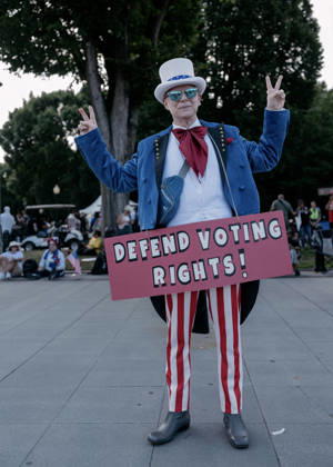 August 28, 2026, Washington, Distict Of Columbia, U.S.A: A demonstrator wearing an Uncle Sam costume holds a sign that reads, â€oeDefend Voting Rights,†while attending the â€oeMarch on Washington: Defend the Vote†rally at the Lincoln Memorial in Washington, DC, on August 28, 2026. The rally, organized by the National Action Network, marks the 63rd anniversary of the 1963 March on Washington, where Rev. Martin Luther King Jr. delivered his historic â€oeI Have a Dream†speech. Thousands of demonstrators are expected to gather to call attention to voting rights ahead of Novemberâ€⠢s midterm elections. Washington U.S.A - ZUMAr125 20260828_fap_r125_007 Copyright: xProbalxRashidx