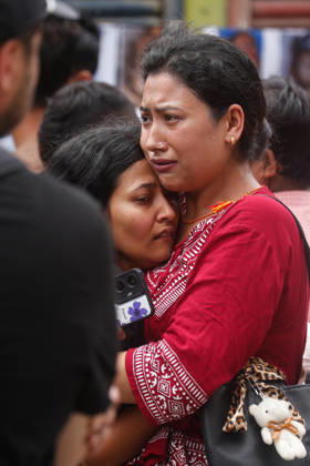 Nepal Floods - Aftermath Relatives of people missing after flash floods in Rasuwa and Nuwakot cry while searching for their loved ones at Tribhuvan University Teaching Hospital on August 30, 2026. Families examine photographs and missing-person notices as search and identification efforts continue. The floods destroyed homes and swept mud and debris downstream along the Trishuli River. Kathmandu Nepal Copyright: xSanjitxPariyarx originalFilename: pariyar-notitle260830_np8Vi