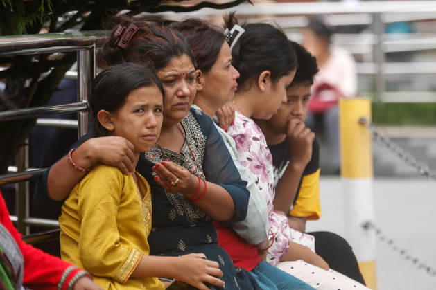 Nepal Floods - Aftermath Relatives of people missing after flash floods in Rasuwa and Nuwakot cry while searching for their loved ones at Tribhuvan University Teaching Hospital on August 30, 2026. Families examine photographs and missing-person notices as search and identification efforts continue. The floods destroyed homes and swept mud and debris downstream along the Trishuli River. Kathmandu Nepal Copyright: xSanjitxPariyarx originalFilename: pariyar-notitle260830_np9j4